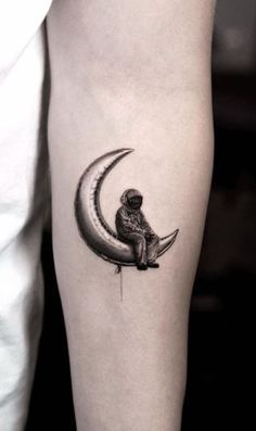 a small owl sitting on the moon tattoo