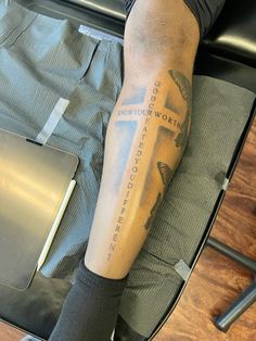 a person with a cross tattoo on their leg