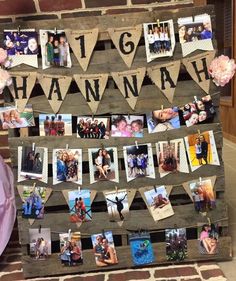 an old pallet is decorated with photos and bunting for a family photo display