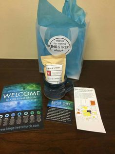 the contents of a welcome kit sitting on a table next to a bag and some pamphlets