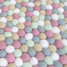 multicolored wool balls are scattered on the surface for use as wallpaper or backdrop