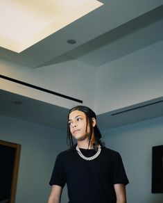 a man with dreadlocks standing in a room