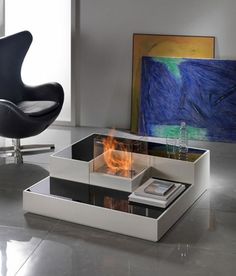 a modern coffee table with fire burning in it