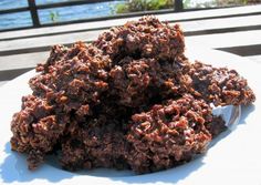 chocolate cookies stacked on top of each other in front of the ocean and grass area