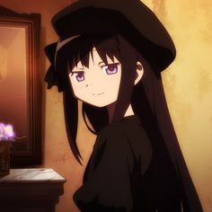 a girl with long black hair wearing a hat