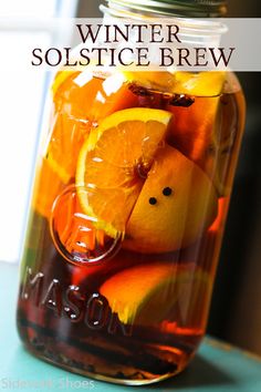 a mason jar filled with oranges and lemon slices