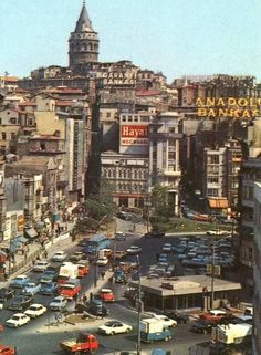 a busy city street filled with lots of traffic and tall buildings on top of it