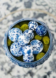 blue and white decorated eggs in a bowl