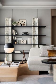 a living room filled with furniture and bookshelves on top of eachother