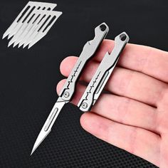 two small scissors are held in the palm of someone's hand