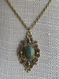 Vintage Victorian Revival Bronze Nephrite Medallion Filigree Necklace 18" Item here is a vintage Victorian Revival bronze filigree medallion necklace with a nephrite stone. This necklace opens and closes with a spring ring clasp. Very neat Victorian design with a lovely green jade stone.  Condition: Great; item is pre-owned and may have some signs of light use and age related wear. Please look closely at the pictures provided as they are an extension of our written description. Measurements: Length: 18 in Chain Width: 3mm Pendant: 2 ⅛ in x 1 ¼ in Weight: 14.8 g 4589C Green Vintage Necklace, Heirloom Necklace Vintage, Luxury Vintage Engraved Medallion Necklace, Gold Victorian Necklace, Fancy Diamond Ring, Dad Jewelry, Victorian Necklace, Vintage Pendant Necklace, Victorian Pendants