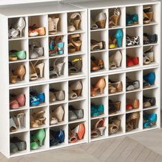 a white shoe storage unit filled with lots of shoes