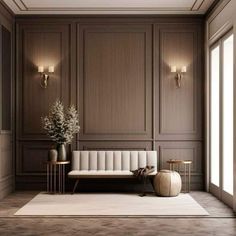 an elegant living room with wood paneling and white furniture, along with two vases filled with flowers