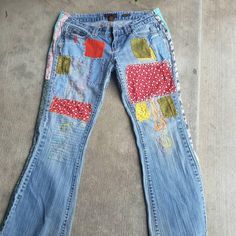 a pair of jeans with patches on them