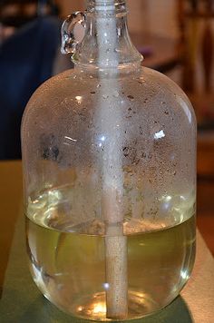 an empty glass bottle sitting on top of a table