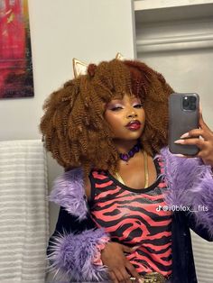 a woman taking a selfie with her cell phone while wearing an animal print top