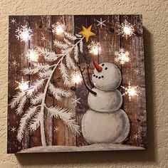 a snowman with a star on his head is standing in front of a christmas tree