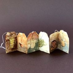 four pieces of paper that have been folded into small bags with different designs on them