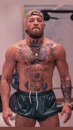 a shirtless man with tattoos on his chest