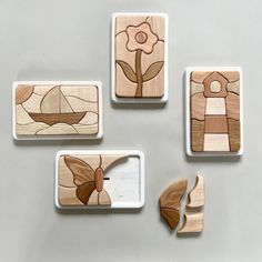 four wooden coasters with flowers and boats on them