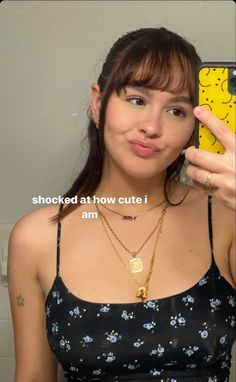 a woman holding up a cell phone in front of her face with the caption shocked at how cute i am