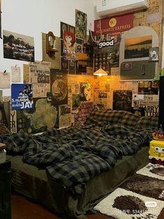 a bed with plaid sheets and pillows in a room filled with posters