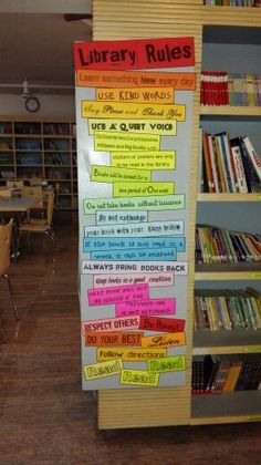 the library rules are written on a bulletin board in front of bookshelves and tables