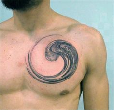 a man with a tattoo on his chest has a wave in the shape of a circle