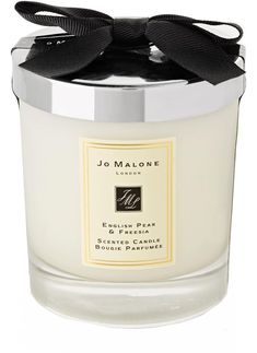 a white candle with a black bow on it's top and the words jol mallon