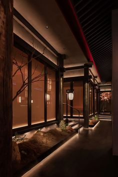 a dimly lit room with trees and lanterns