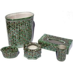 four pieces of green glass with designs on the top and bottom, all in different sizes