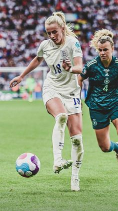 two female soccer players in action on the field