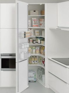 an open refrigerator in a white kitchen