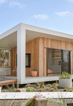 a modern house with wooden siding and white walls