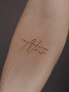 a person with a tattoo on their arm that says the power of our love written in cursive writing