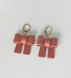 Handmade polymer clay bows in the color terracotta with a gold plated huggie hoop Trendy Rose Gold Drop Earrings, Trendy Drop Earrings For Gifts, Trendy Handmade Dangle Jewelry, Trendy Small Hoop Rose Gold Jewelry, Chic Brown Dangle Jewelry, Trendy Rose Gold Small Hoop Jewelry, Cute Small Hoop Pink Jewelry, Chic Small Hoop Pink Jewelry, Chic Small Pink Hoop Earrings