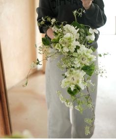 a person holding a bouquet of flowers in front of a mirror