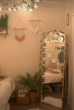 a room with a bed, mirror and plants on the wall next to each other