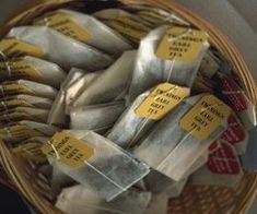 a basket filled with lots of different types of wrapped food in wrappers and tags