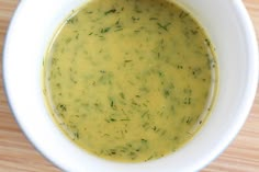 a white bowl filled with soup on top of a wooden table