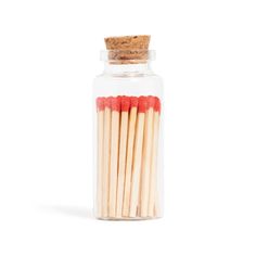 matches are in a glass jar on a white background