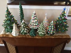 small christmas trees are lined up on a table