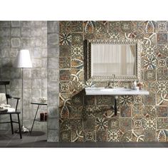 a bathroom with a sink, mirror and tiled walls in different colors on the wall