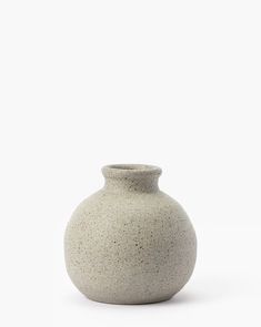 a white vase sitting on top of a table