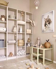 a baby's room with toys and bookshelves