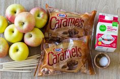 apples, marshmallows, and caramel sticks are on the table next to bags of caramels