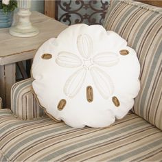 a white pillow sitting on top of a couch