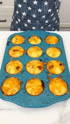 muffins sitting in a blue pan on top of a counter