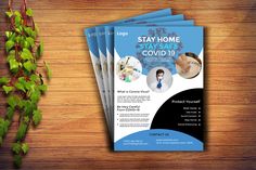 three flyers for stay home stay safe covidd 19 on a wooden table with ivy