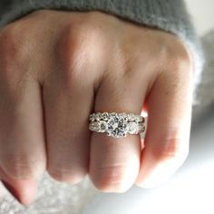 a woman's hand with a diamond ring on it